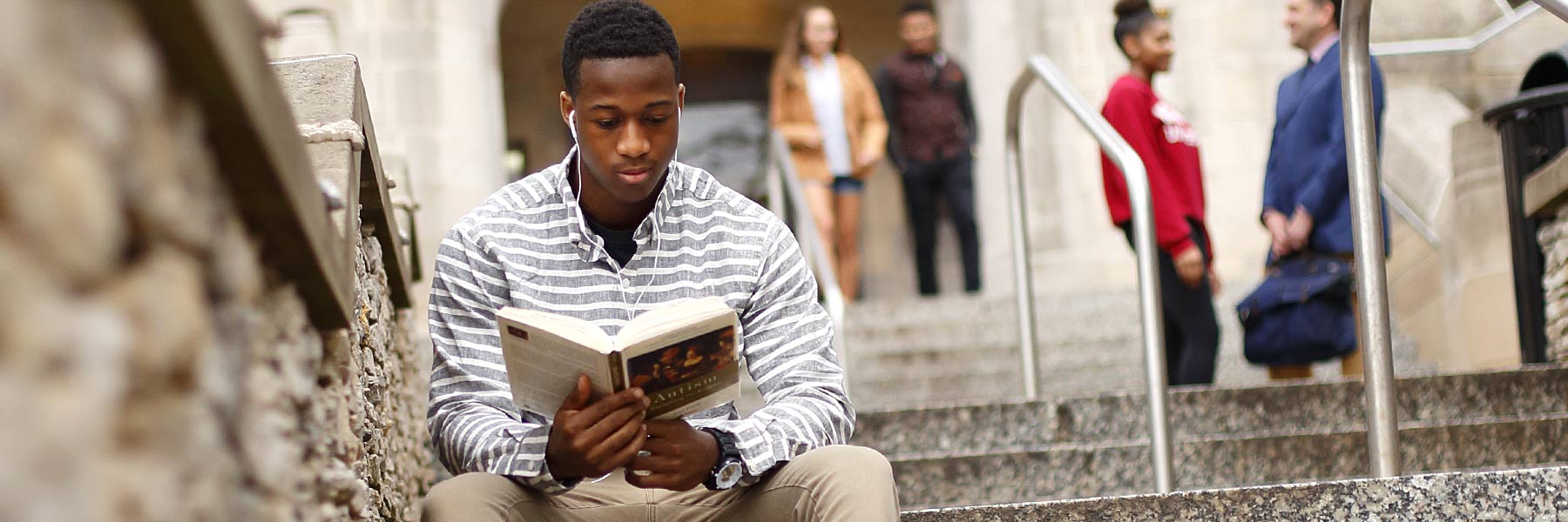 A student studies outdoors