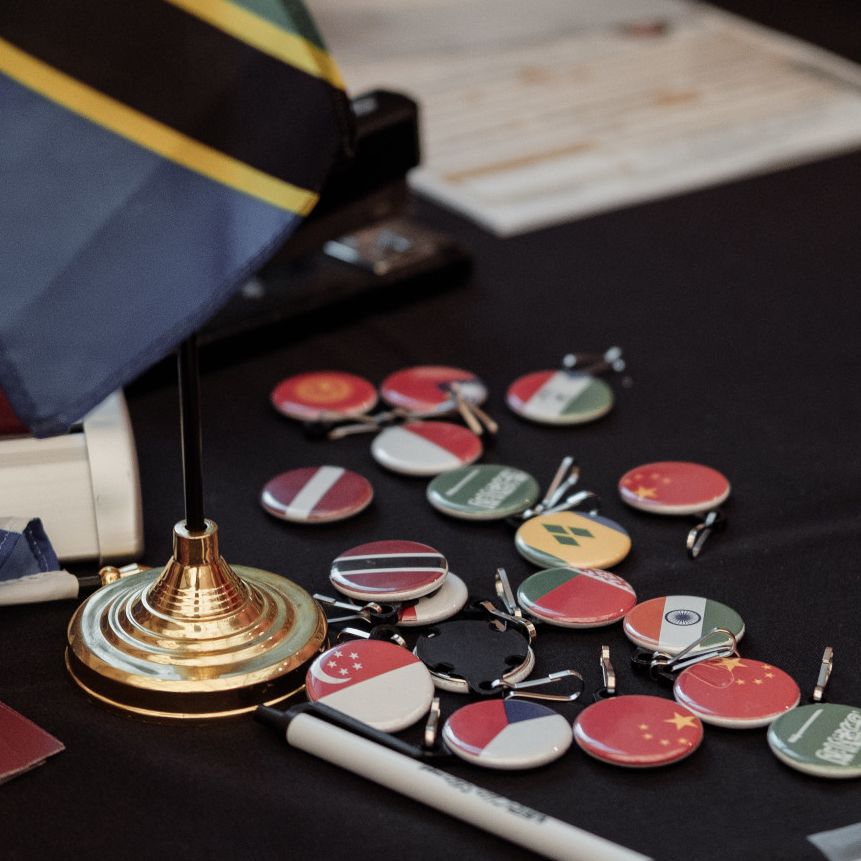 Buttons and a flag representing foreign countries displayed at the Passport Caravan.