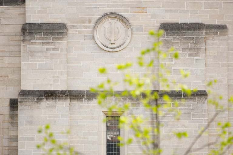 An Indiana University trident adorns the side of the IU Auditorium on a spring evening at IU Bloomington on Wednesday, April 22, 2020.