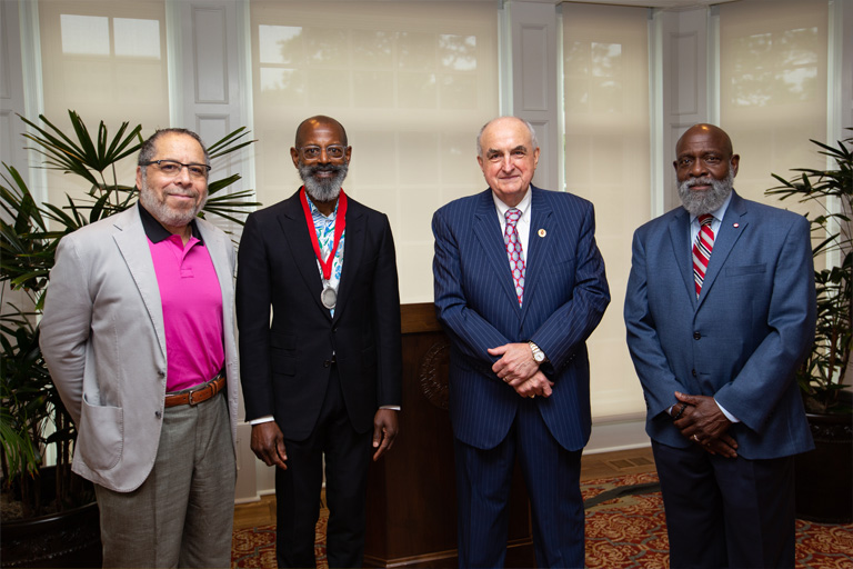IU President McRobbie in a group photo with James Wimbush, Charlie Nelms, Ed Marshall.