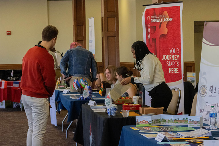 Attendees at the study abroad fair speaking with booth reps.