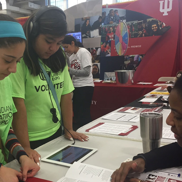 Participants play an interactive game on an iPod during the Indiana Latino Expo.