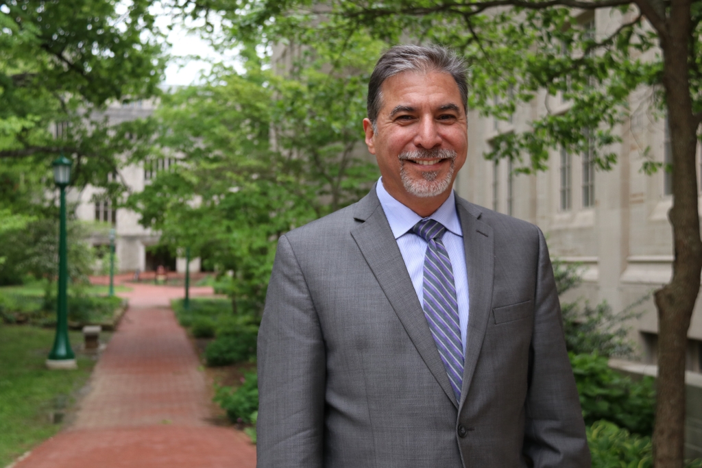 John Nieto-Phillips stands in front of academic buildings on the IU campus. 